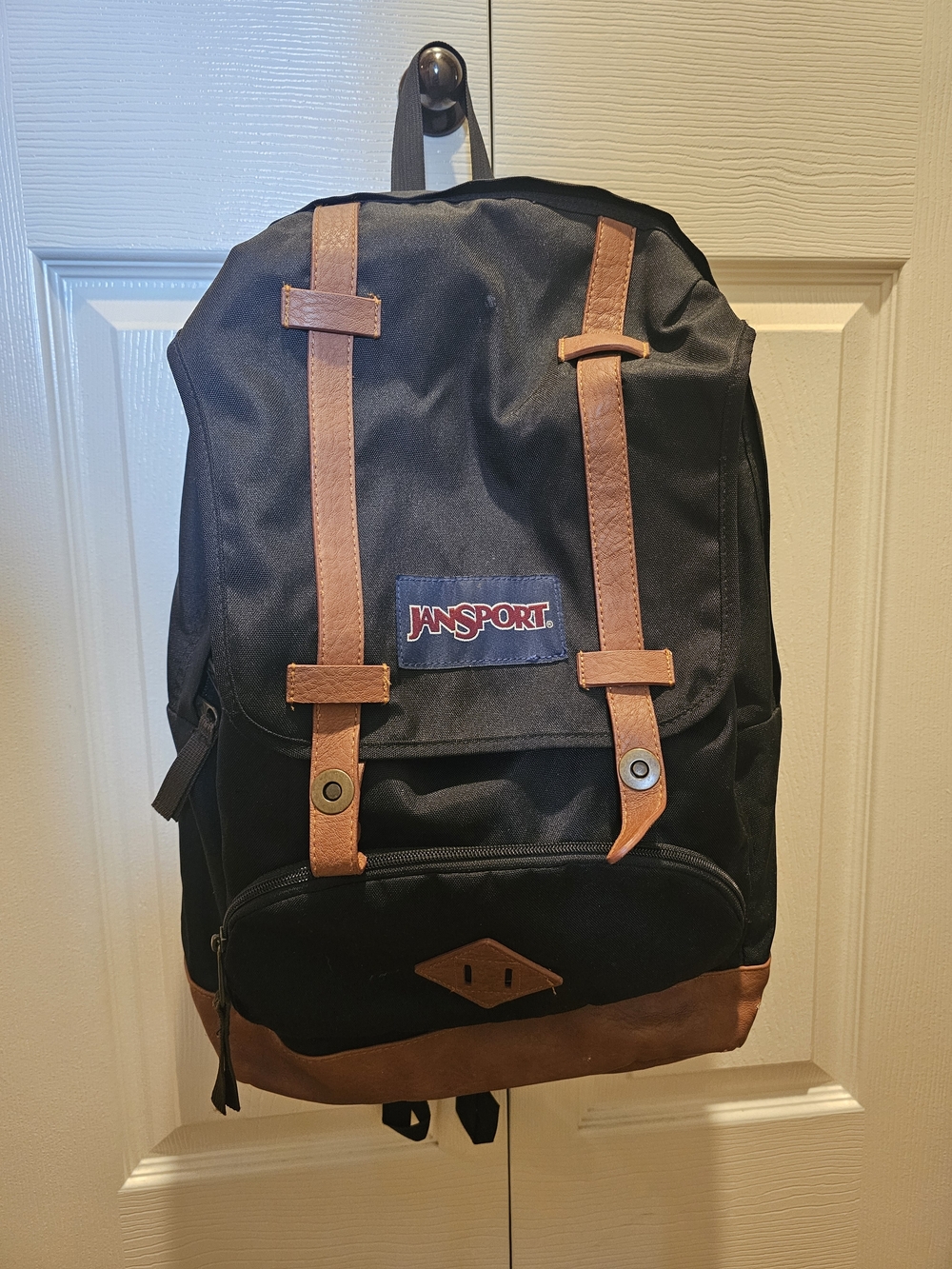 JanSport Black Backpack with Brown Accents - Classic Everyday Bag